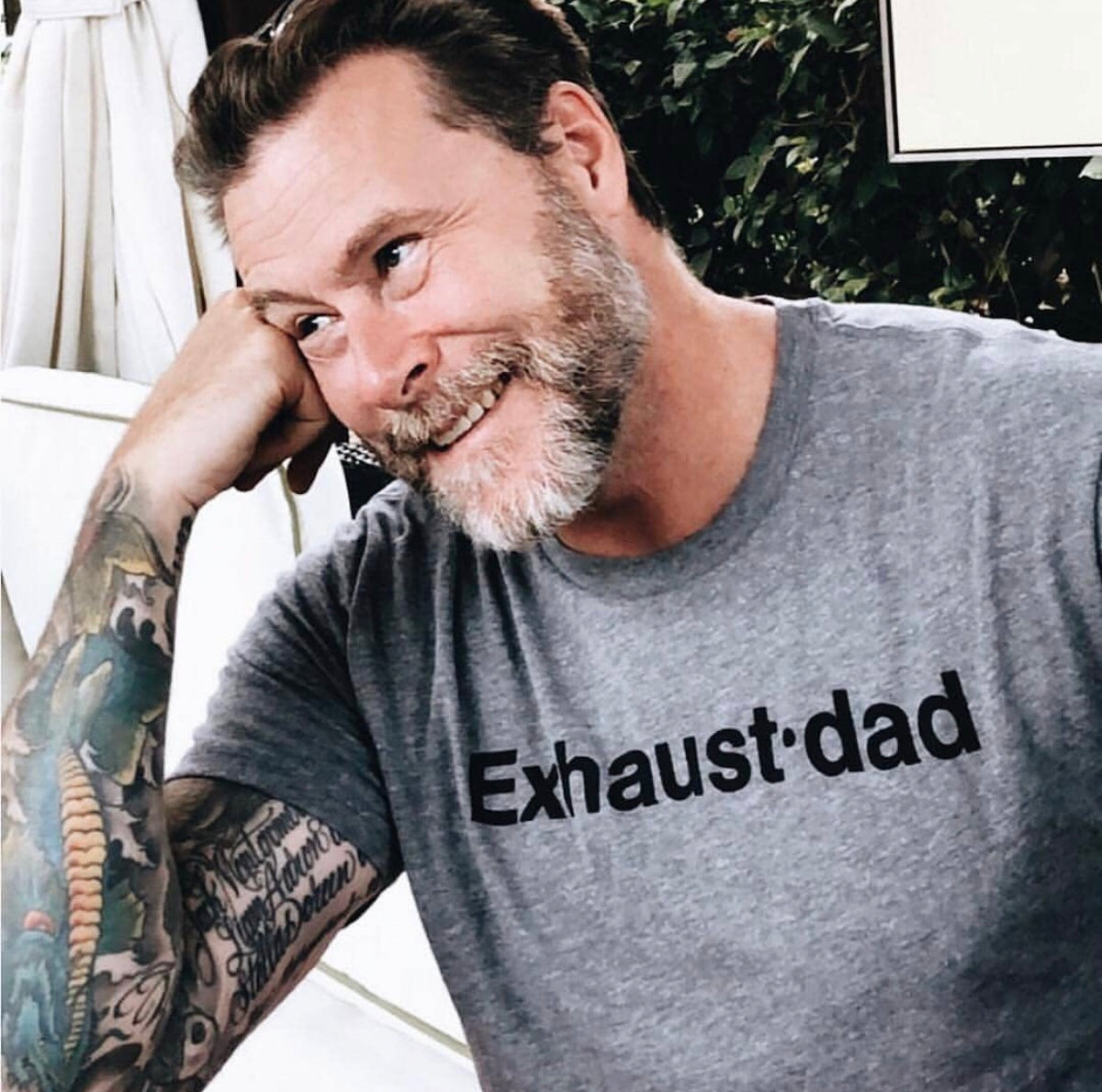 Man wearing a heather gray T-shirt with black “Exhaust•dad” lettering.