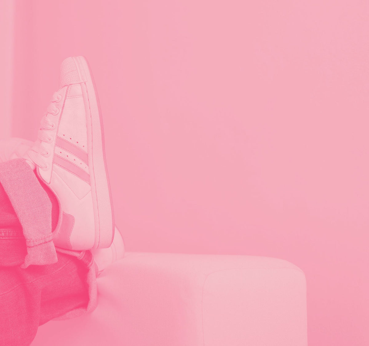 Pink-tinted photo of a backpack resting on a bench.
