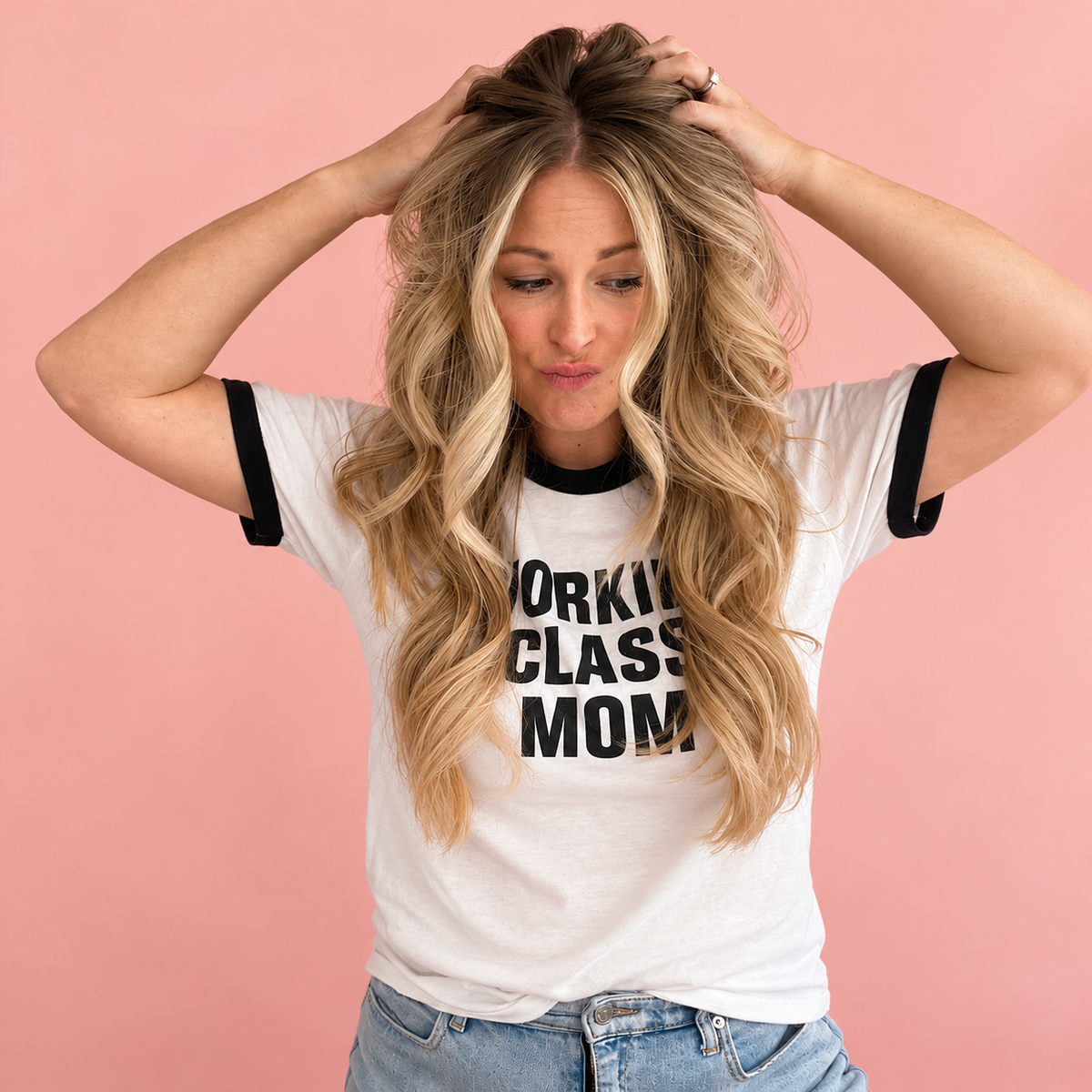 Sarah with hands in her hair against a blush pink backdrop for her ADHD and perimenopause story