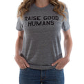 Woman wearing a heather gray crewneck T-shirt with black “Raise Good Humans” lettering.