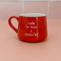 Red ceramic mug with white “Teaching Tiny Humans Is Exhausting” lettering.
